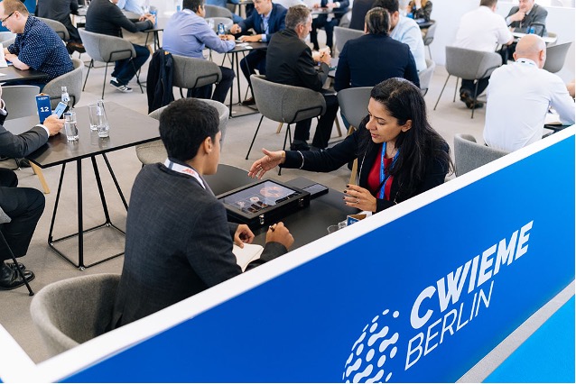 Several occupied tables focusing on two people talking to each other during a CWIEME Berlin Conference.