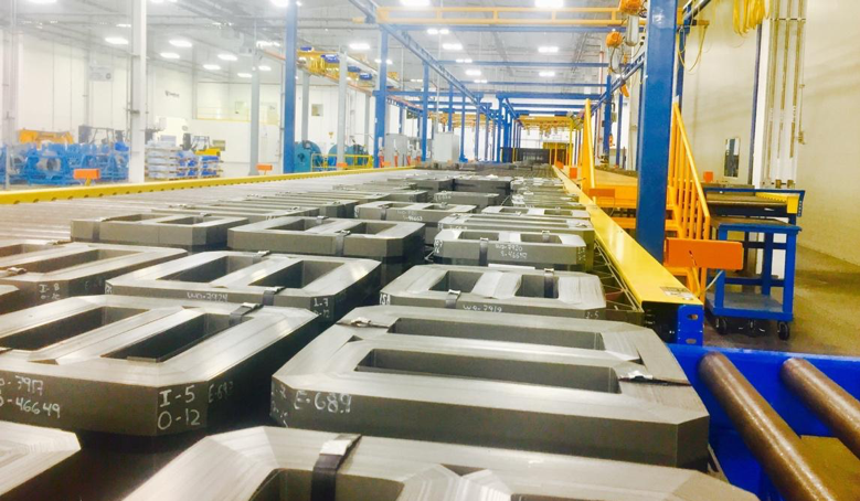 Corefficient’s brightly lit electrical transformer core manufacturing plant in Monterrey, Mexico, showcasing countless quality transformer cores neatly placed on the assembly line.