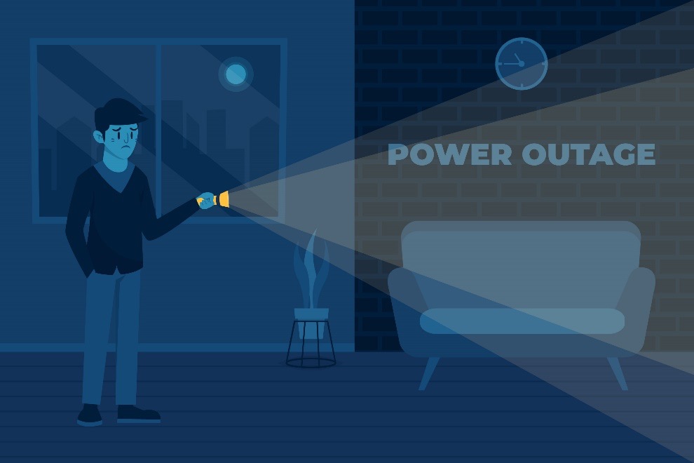 : A dimly lit room where the absence of light suggests a power interruption. A silhouette of an individual holding a flashlight that casts a beam across the room, revealing the words "POWER OUTAGE" on a brick wall.