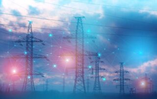 A field of silhouetted transformers at sunset, a sky filled with darker cloud on the horizon with various shades of red and orange peeking through. A graphic “grid overlay” creates a feeling of connection between each electrical power transformer, with certain connection points glowing like small red and blue orbs.