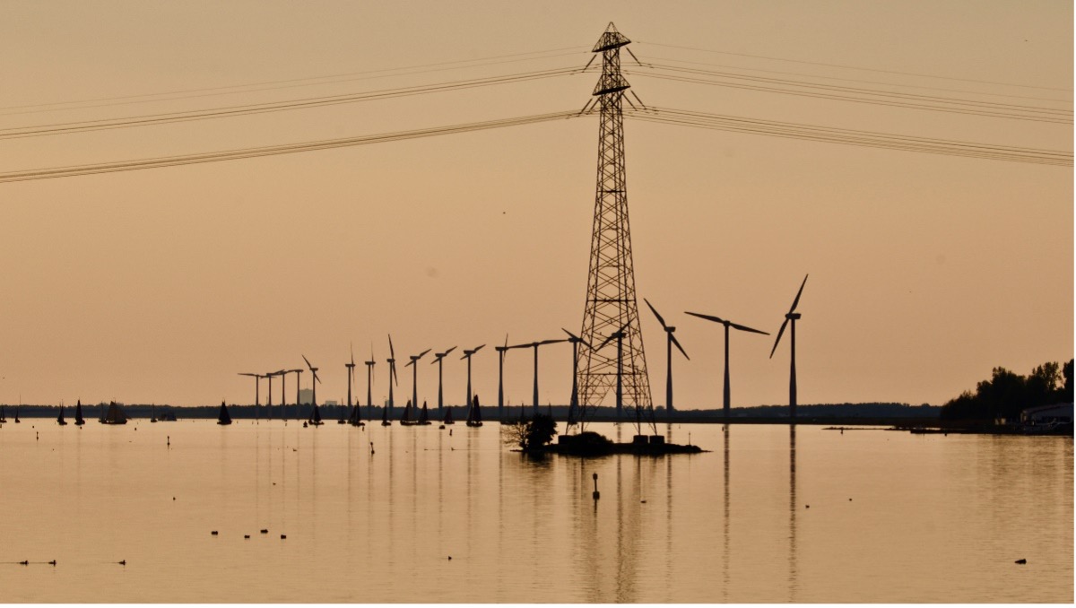 A power line tower in the middle of a body of water